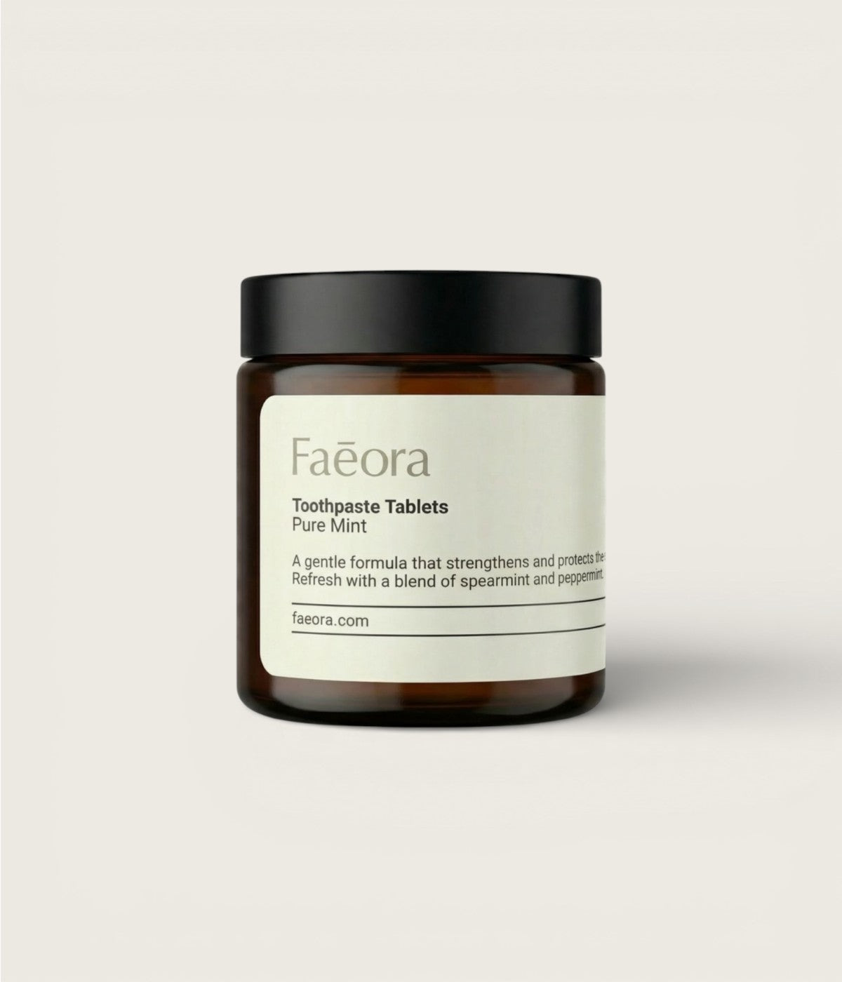 Jar of Pure Mint Faeora toothpaste tablets on a light gray background.