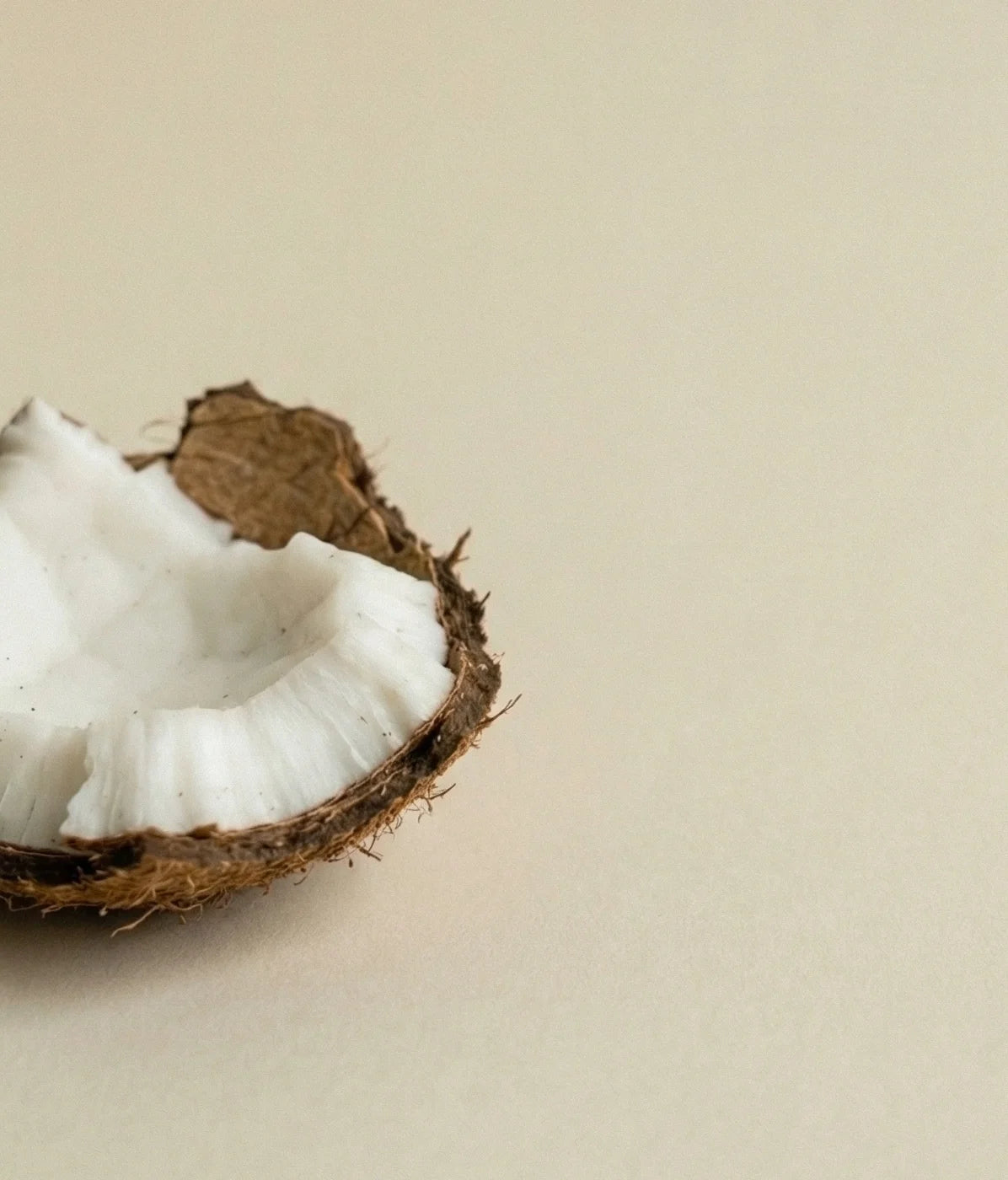 Faeora open coconut on a beige background. 